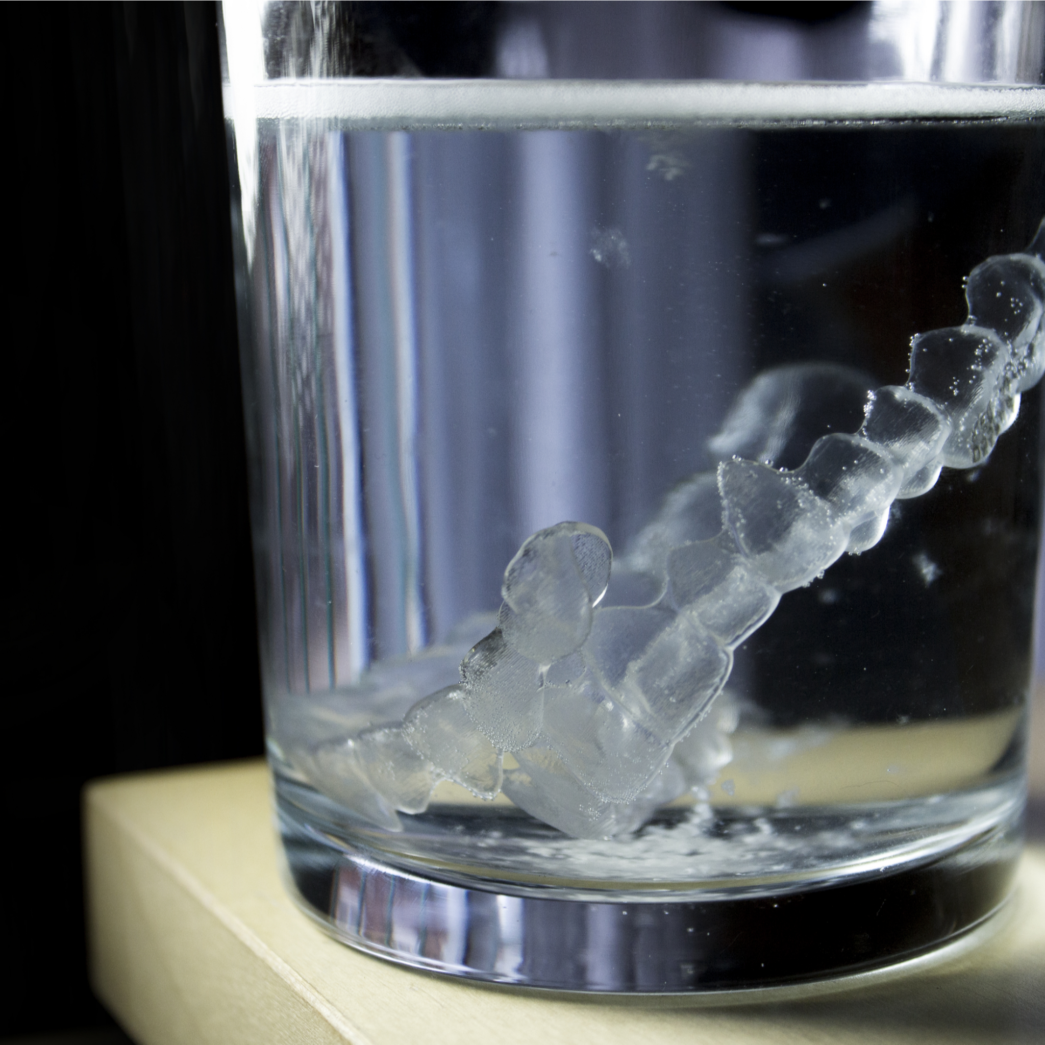 aligners soaking in a glass of water